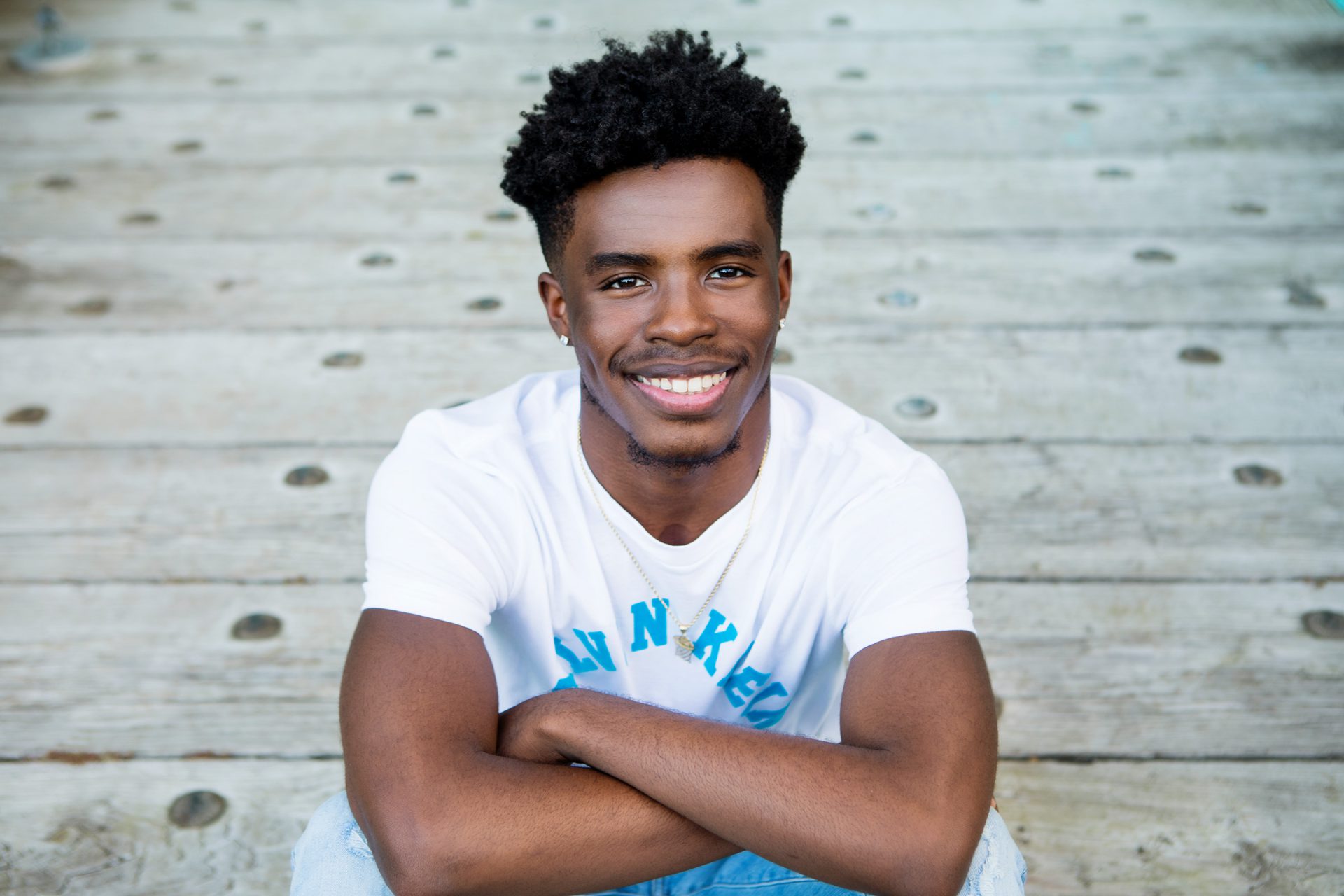 Senior Boy sitting on Bridge in High Falls Rochester NY